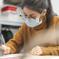 Student wearing face-mask studying